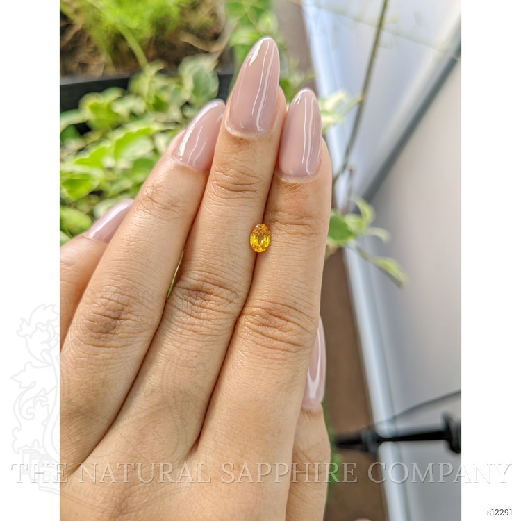 0.56 Ct. Orangish Yellow Sapphire from Ceylon (Sri Lanka)