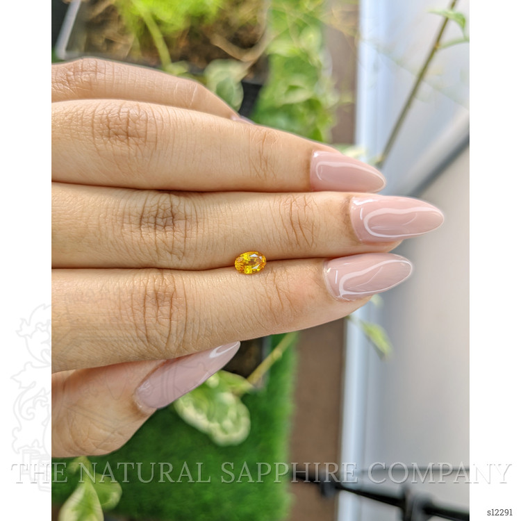 0.56 Ct. Orangish Yellow Sapphire from Ceylon (Sri Lanka)