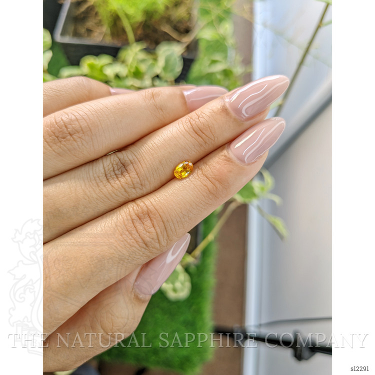 0.56 Ct. Orangish Yellow Sapphire from Ceylon (Sri Lanka)