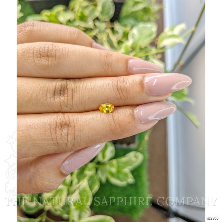 0.56 Ct. Orangish Yellow Sapphire from Ceylon (Sri Lanka)