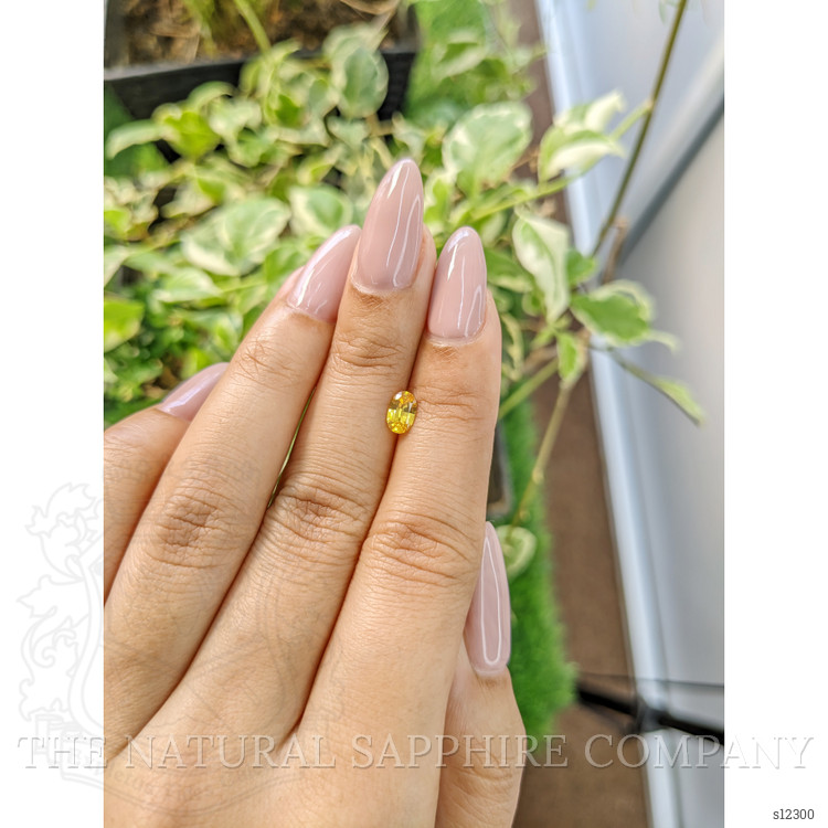 0.56 Ct. Orangish Yellow Sapphire from Ceylon (Sri Lanka)