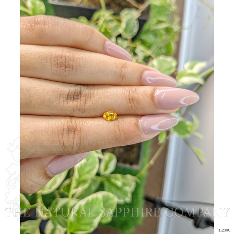 0.65 Ct. Orangish Yellow Sapphire from Ceylon (Sri Lanka)