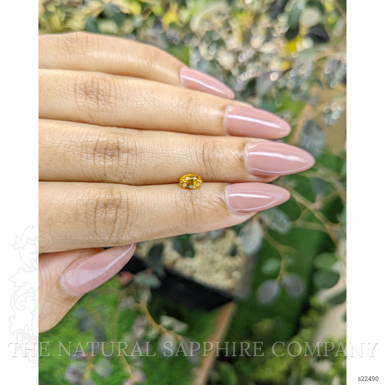 0.59 Ct. Orangish Yellow Sapphire from Ceylon (Sri Lanka)