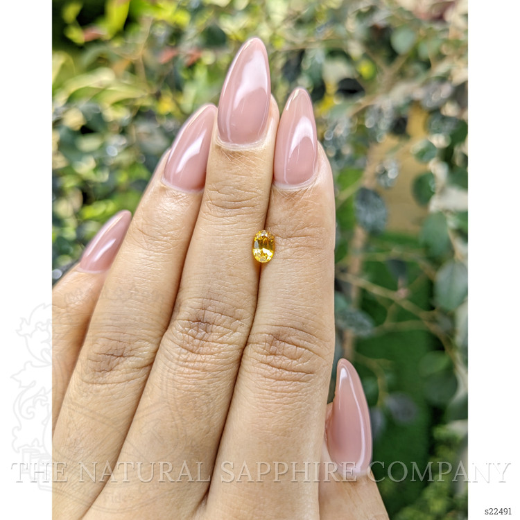 0.69 Ct. Orangish Yellow Sapphire from Ceylon (Sri Lanka)