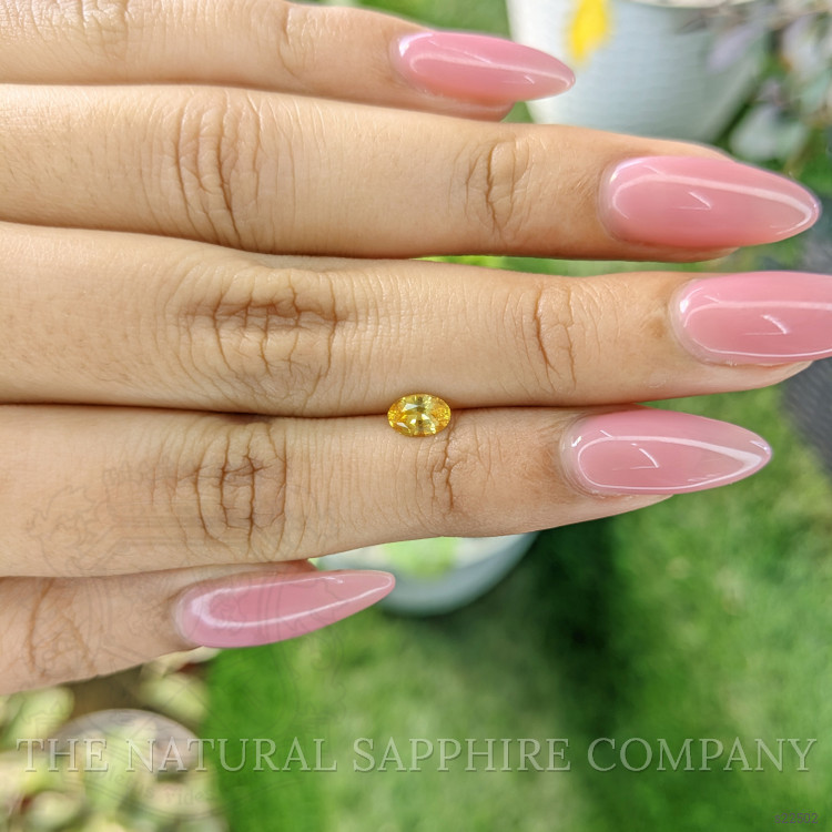 0.54 Ct. Orangish Yellow Sapphire from Ceylon (Sri Lanka)
