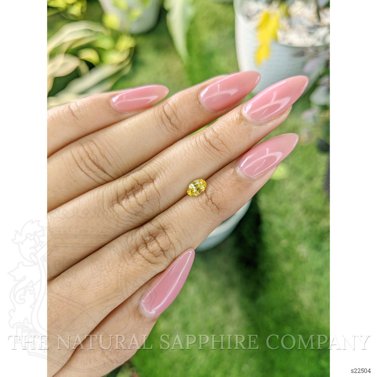 0.60 Ct. Orangish Yellow Sapphire from Ceylon (Sri Lanka)