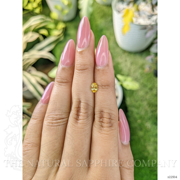 0.60 Ct. Orangish Yellow Sapphire from Ceylon (Sri Lanka)