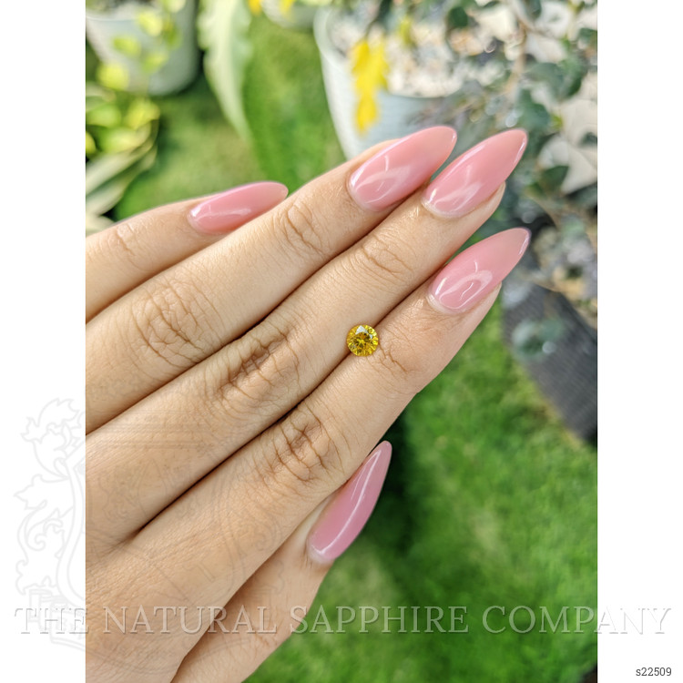 0.58 Ct. Orangish Yellow Sapphire from Ceylon (Sri Lanka)