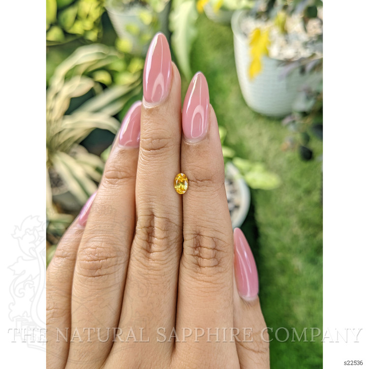 0.58 Ct. Orangish Yellow Sapphire from Ceylon (Sri Lanka)