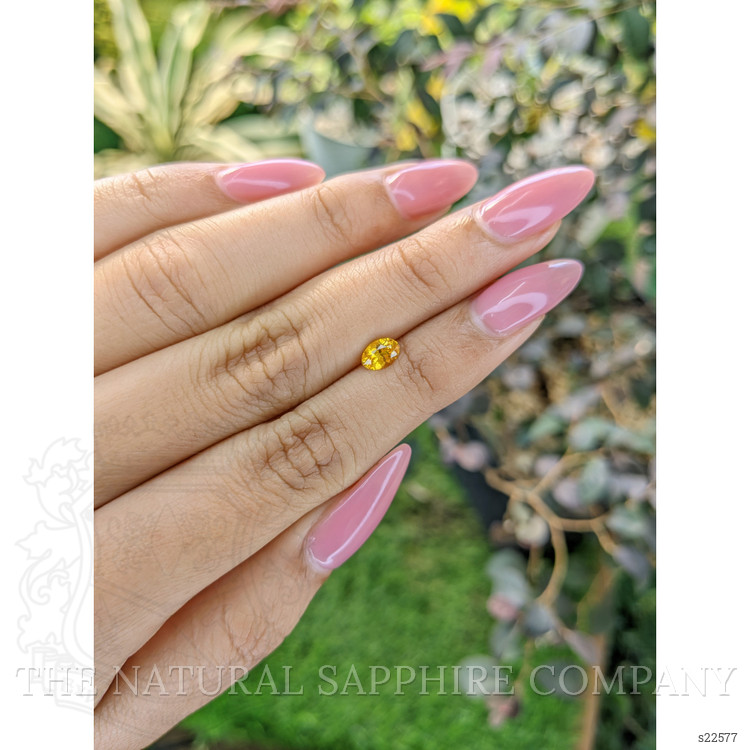 0.60 Ct. Orangish Yellow Sapphire from Ceylon (Sri Lanka)