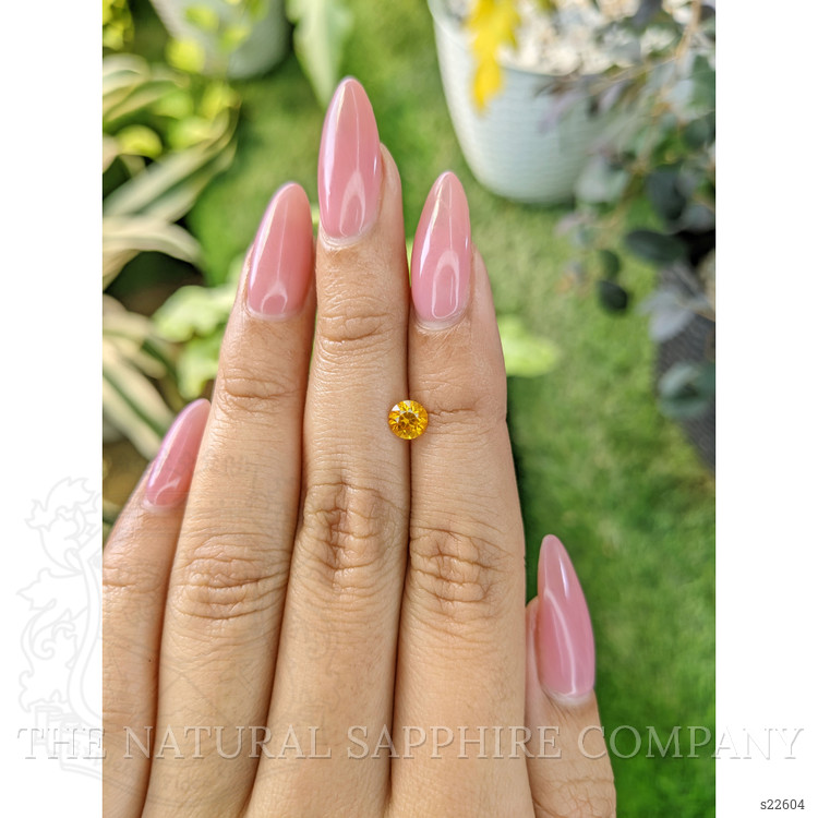 0.65 Ct. Orangish Yellow Sapphire from Ceylon (Sri Lanka)