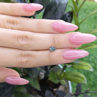 0.65 Ct. Bluish Green Sapphire from Madagascar Life Style