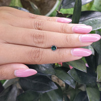 0.46 Ct. Bluish Green Sapphire from Madagascar Life Style