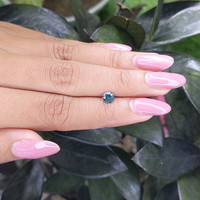 0.55 Ct. Bluish Green Sapphire from Madagascar Life Style
