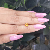 0.80 Ct. Orangish Yellow Sapphire from Madagascar Life Style