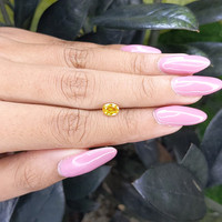 0.69 Ct. Orangish Yellow Sapphire from Madagascar Life Style