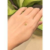 0.45 Ct. Greenish Yellow Cabochon Sapphire from Ceylon (Sri Lanka) Life Style