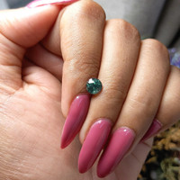 0.99 Ct. Bluish Green Sapphire from Madagascar Life Style