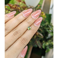 0.62 Ct. Yellowish Green Sapphire from Madagascar Life Style