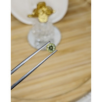 0.64 Ct. Greenish Yellow Sapphire from Madagascar Life Style