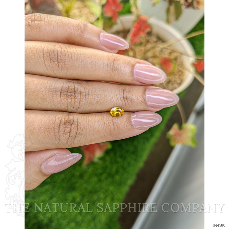0.73 Ct. Orangish Yellow Sapphire from Ceylon (Sri Lanka)